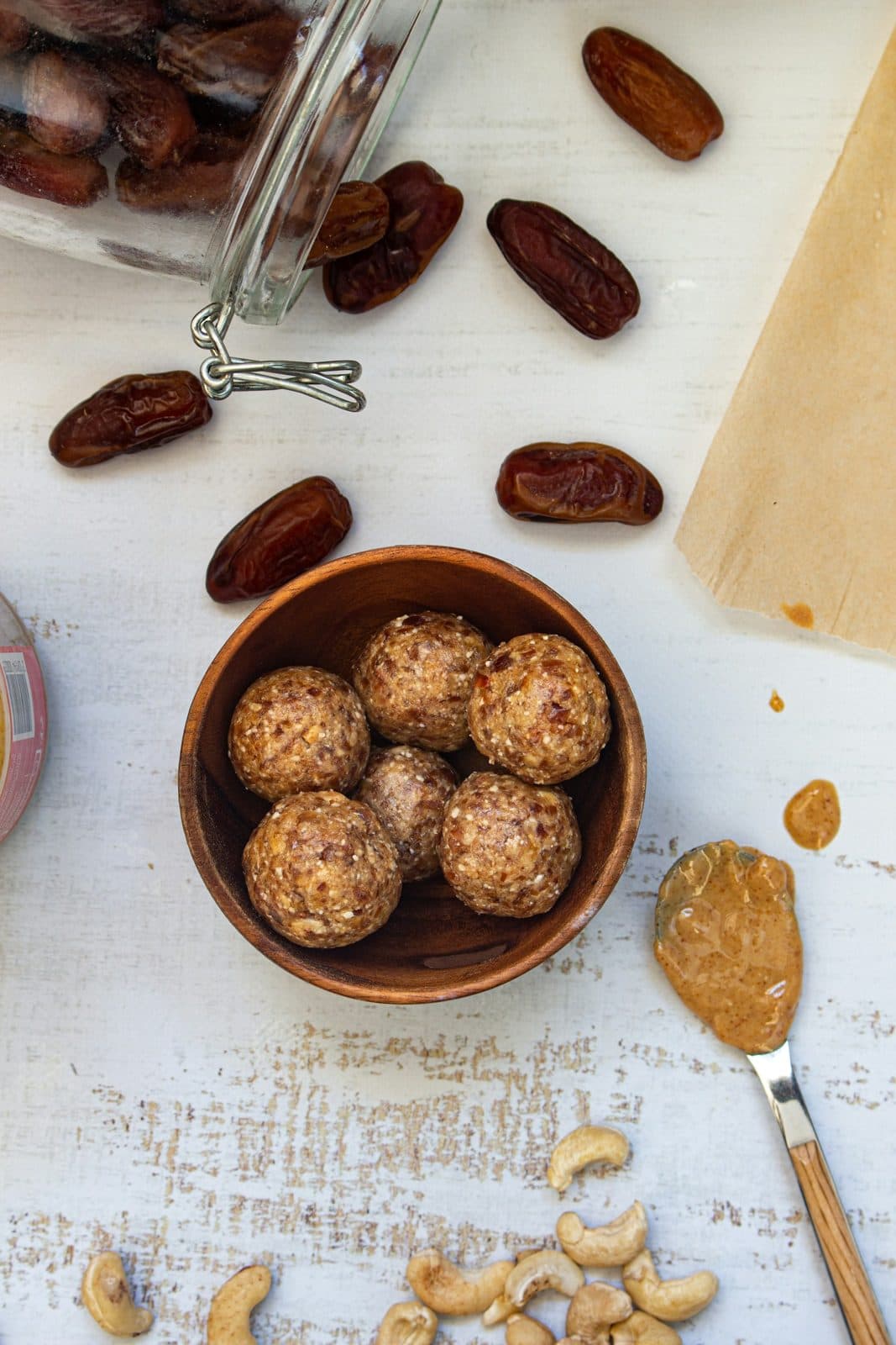 Dry fruit laddoos in a bowl with dates and cashews