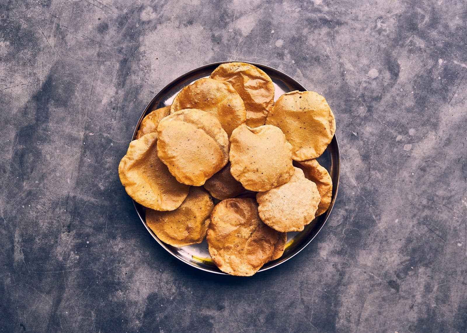 Flaky masala mathri on a plate