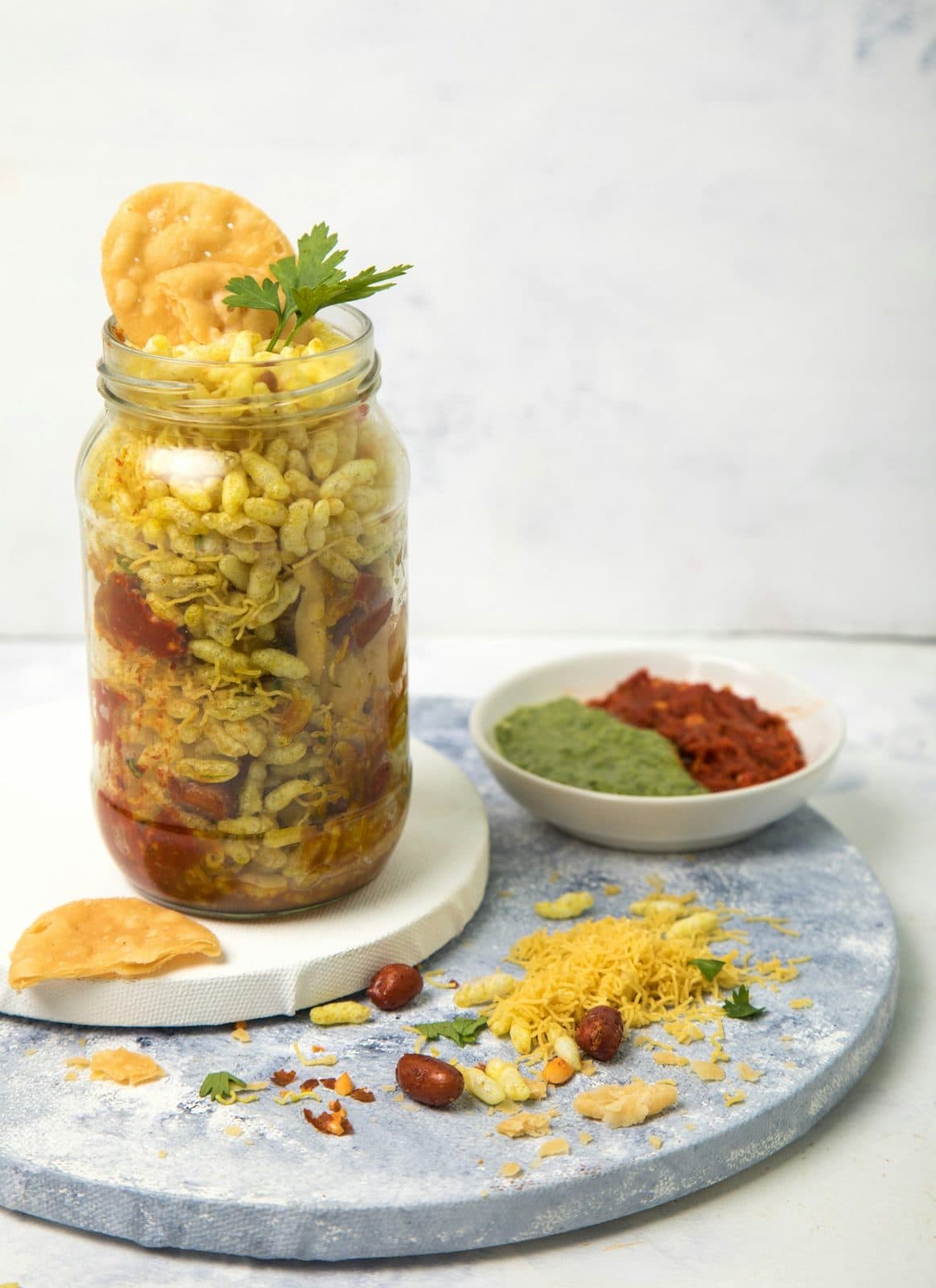 A jar of navratan mixture with sev and peanuts